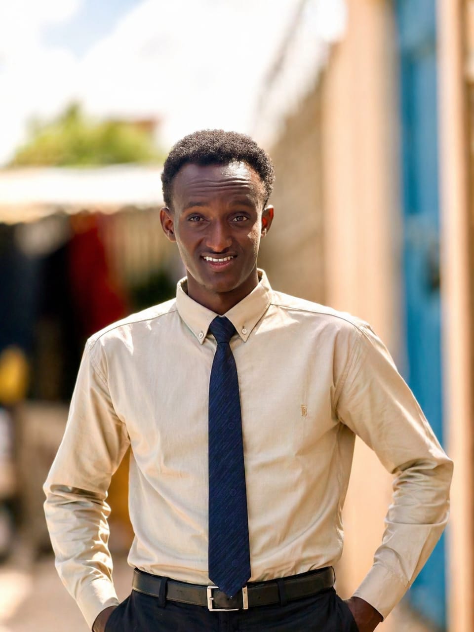 Hassan Yusuf standing outdoors in professional clothing
